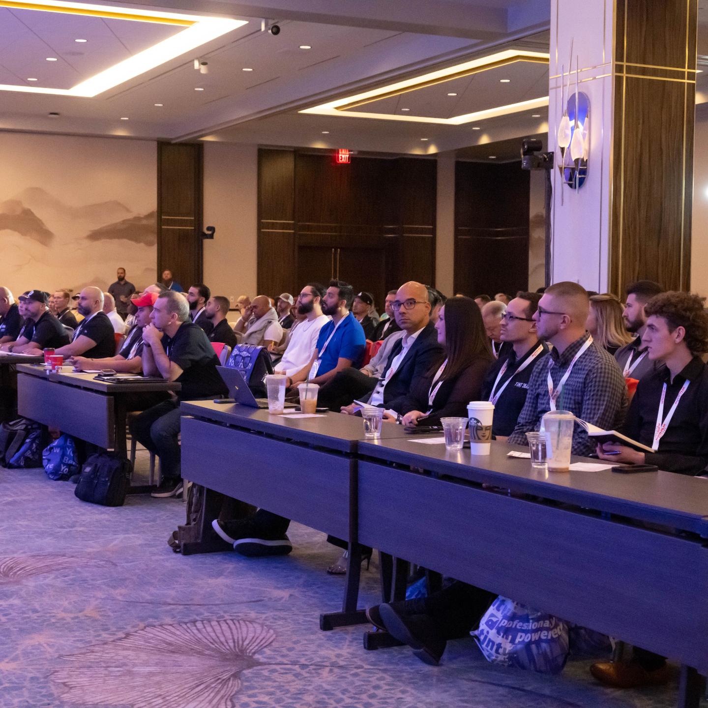 Attendees seated at tables during a session at a previous Auto Film Mastery conference.